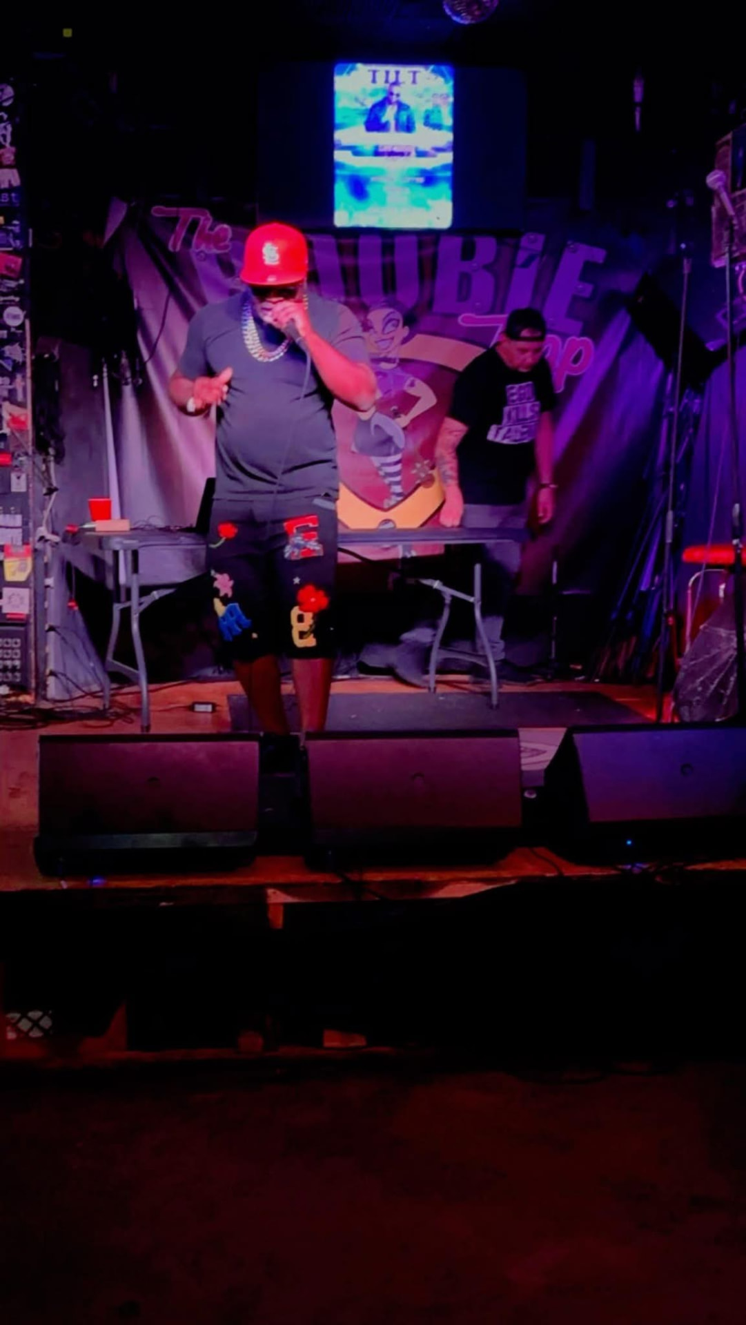 Tilt performing live on stage with a microphone