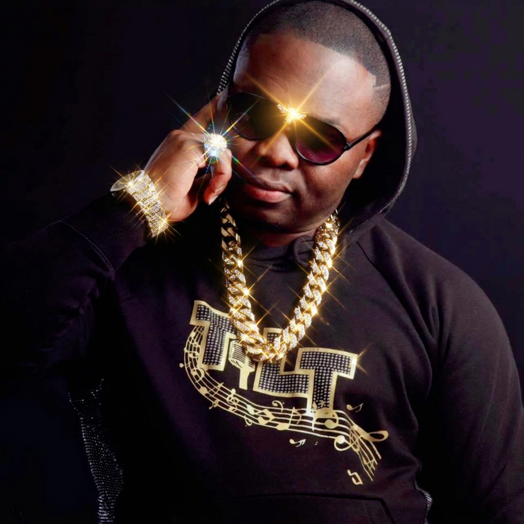 Tilt wearing a hooded TILT sweatshirt and gold chain